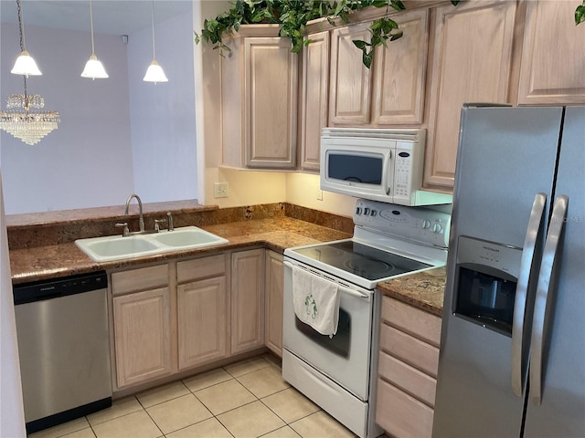 kitchen featuring sink, decorative light fixtures, light brown cabinets, and appliances with stainless steel finishes