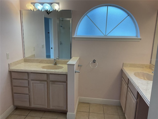 bathroom with a shower with door, vanity, tile patterned flooring, and a chandelier