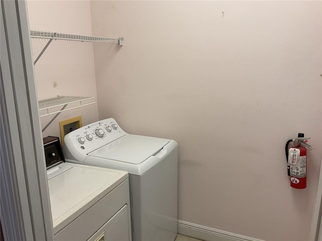 clothes washing area featuring separate washer and dryer