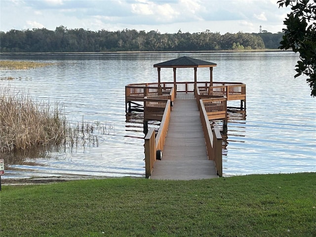 view of dock with a gazebo and a water view