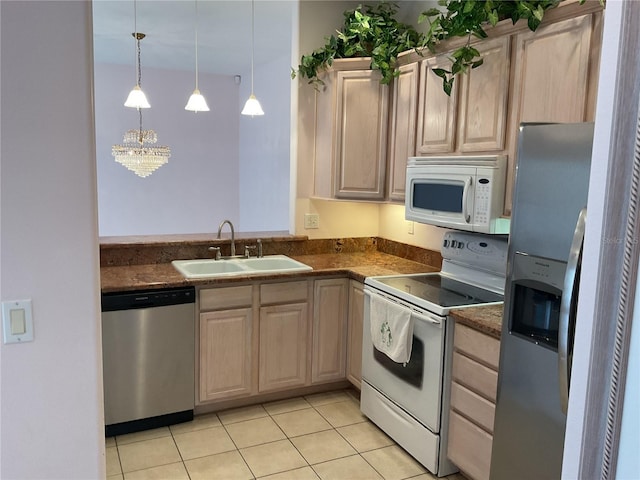 kitchen with sink, appliances with stainless steel finishes, light tile patterned flooring, light brown cabinetry, and decorative light fixtures