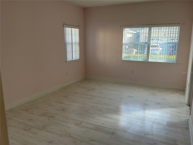 spare room featuring light hardwood / wood-style floors