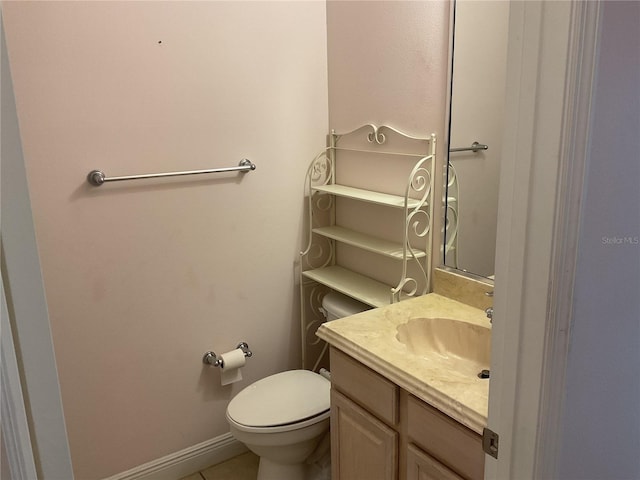 bathroom with vanity, tile patterned flooring, and toilet