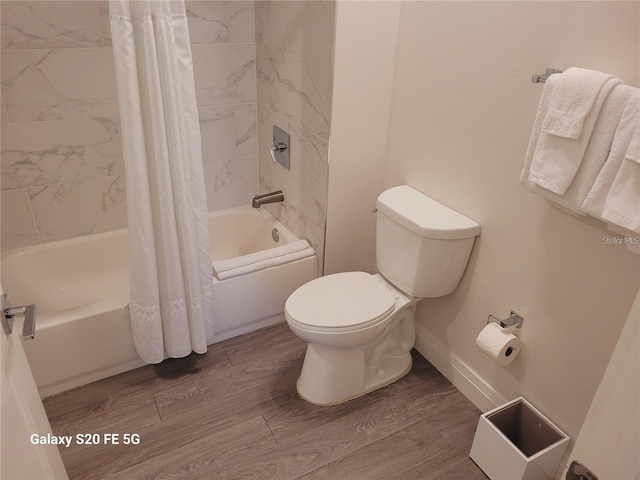 bathroom with hardwood / wood-style floors, shower / bath combination with curtain, and toilet