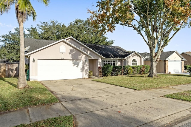 single story home with a garage and a front yard