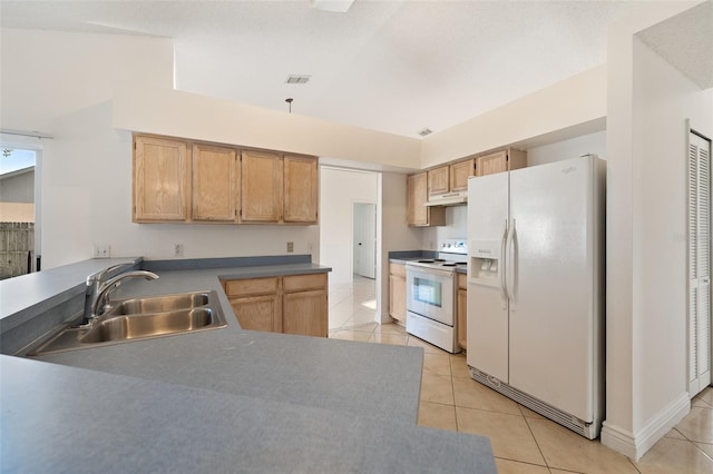 kitchen with sink, light tile patterned floors, and white appliances