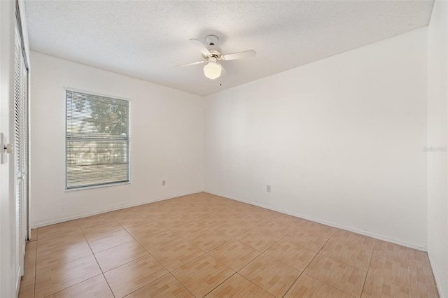 spare room with a textured ceiling and ceiling fan