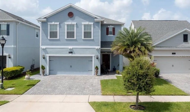 view of front of home with a garage and a front lawn