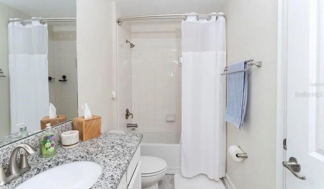 full bathroom featuring vanity, shower / bathtub combination with curtain, and toilet