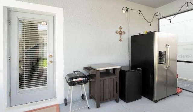 kitchen featuring a healthy amount of sunlight and stainless steel fridge with ice dispenser