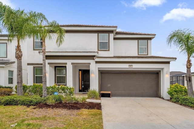 view of front of house with stucco siding, driveway, and a garage