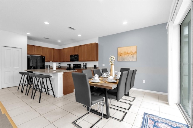 dining area with sink and light tile patterned flooring