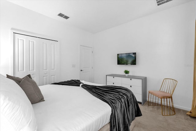 bedroom featuring a closet and light colored carpet