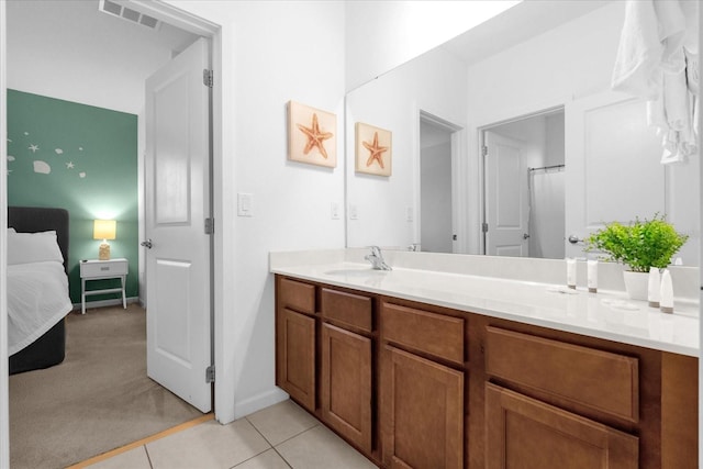 bathroom featuring tile patterned flooring and vanity