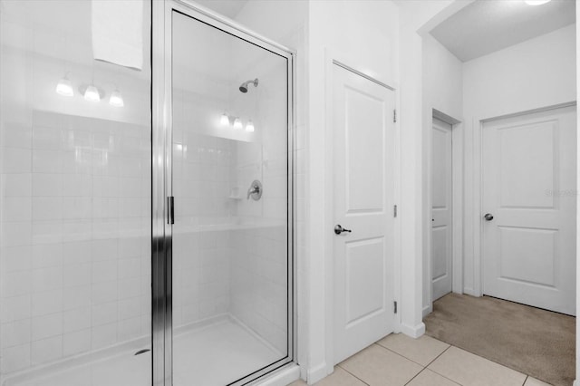 bathroom featuring tile patterned flooring and an enclosed shower