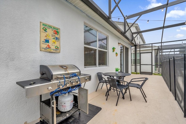 view of patio / terrace with glass enclosure and a grill