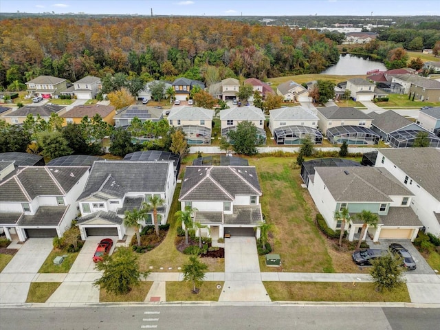 drone / aerial view featuring a residential view and a view of trees