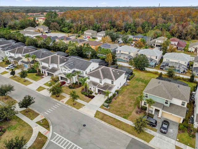 aerial view featuring a residential view and a view of trees