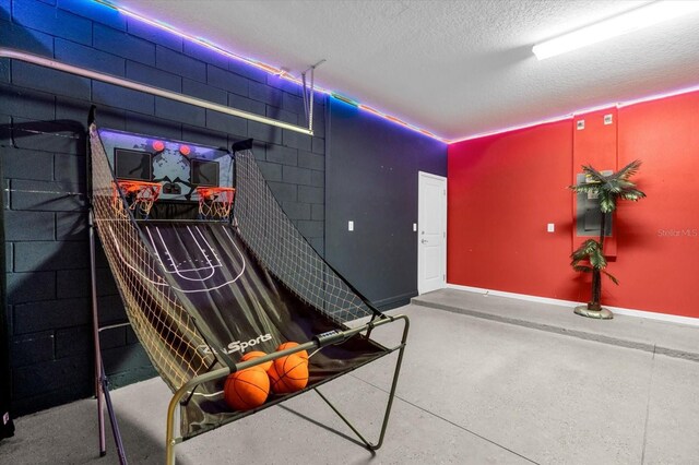 4501 Monado Dr, Kissimmee, FL 34746 - interior space featuring a textured ceiling, concrete block wall, and baseboards