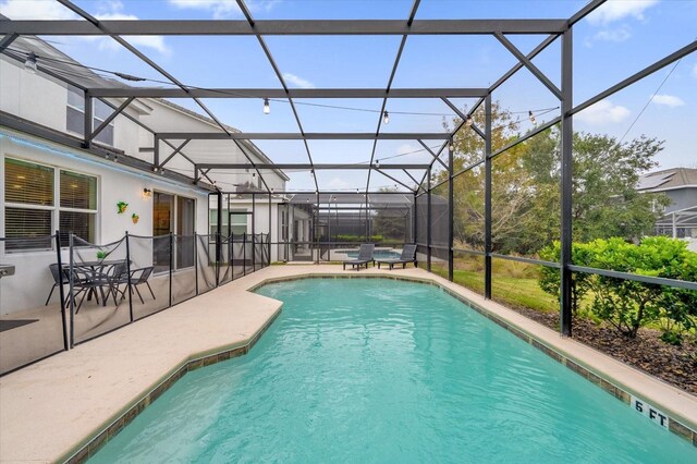 4501 Monado Dr, Kissimmee, FL 34746 - outdoor pool featuring glass enclosure and a patio
