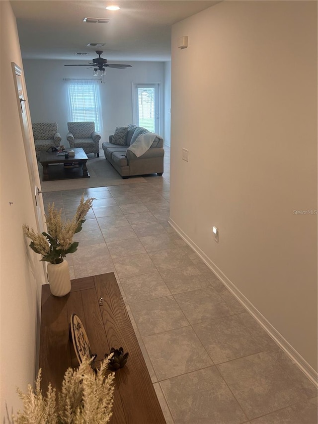 corridor featuring light tile patterned floors