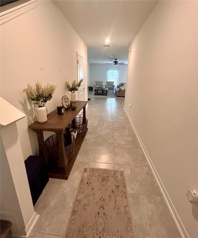 hall featuring light tile patterned flooring