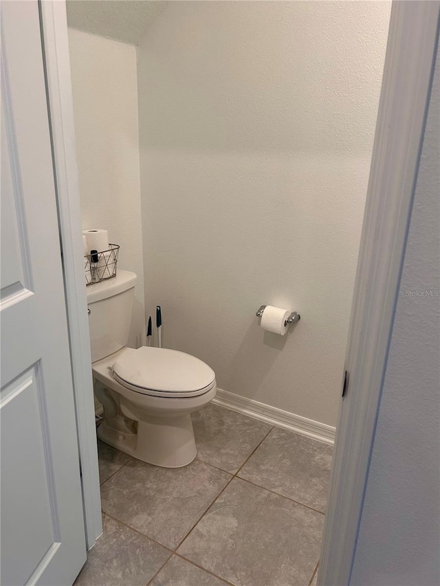 bathroom featuring tile patterned flooring and toilet