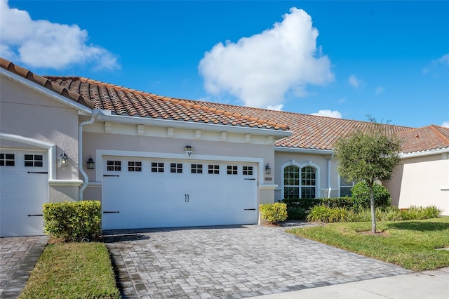 mediterranean / spanish-style house with a garage