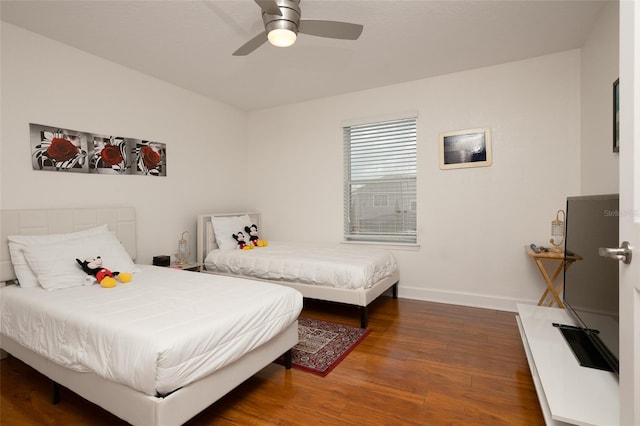 bedroom featuring ceiling fan and dark wood-type flooring