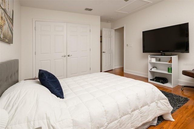 bedroom featuring hardwood / wood-style floors and a closet