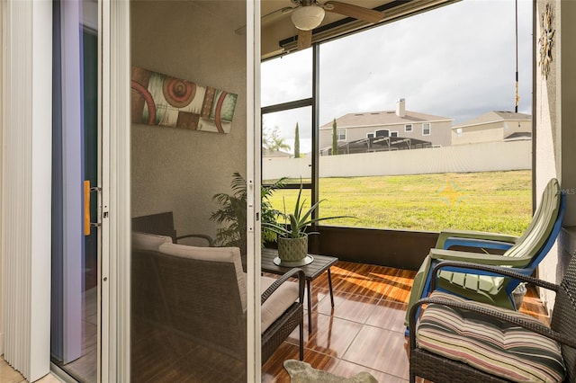 sunroom / solarium featuring ceiling fan