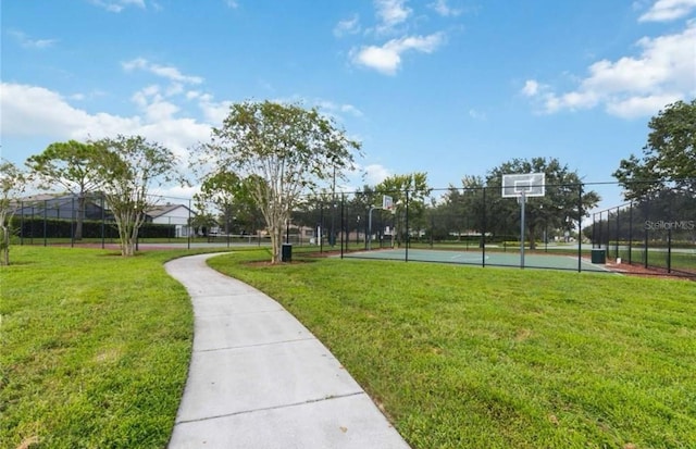 surrounding community with a lawn and basketball hoop