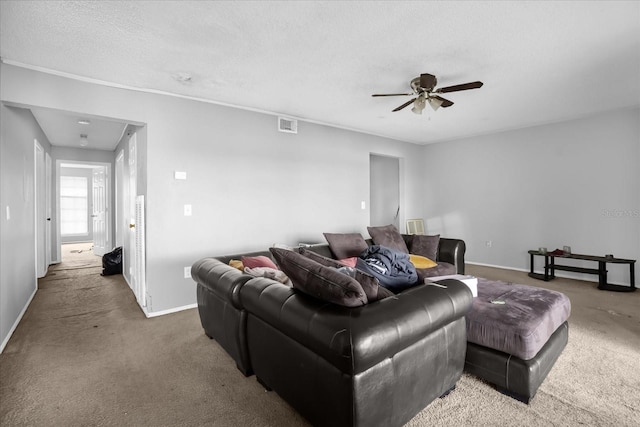 living room with carpet, a textured ceiling, and ceiling fan