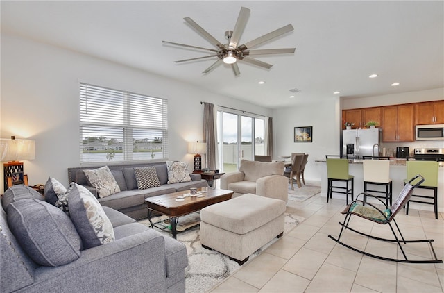 living room featuring ceiling fan and light tile patterned floors