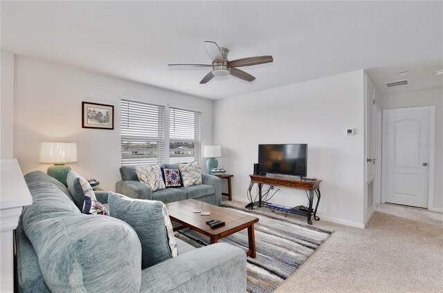 carpeted living room featuring ceiling fan