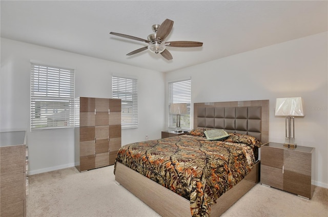 bedroom featuring ceiling fan and light carpet