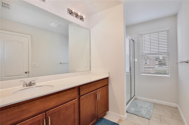 bathroom featuring vanity, tile patterned floors, and walk in shower