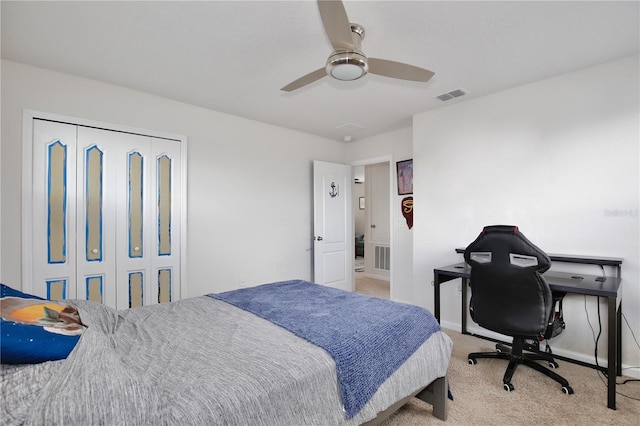 bedroom featuring light carpet, a closet, and ceiling fan