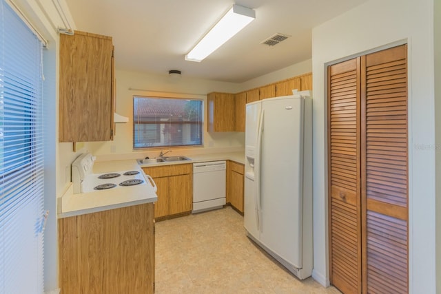 kitchen with exhaust hood, white appliances, and sink