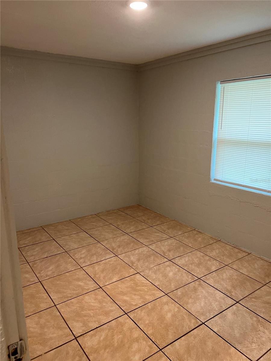 tiled empty room with ornamental molding