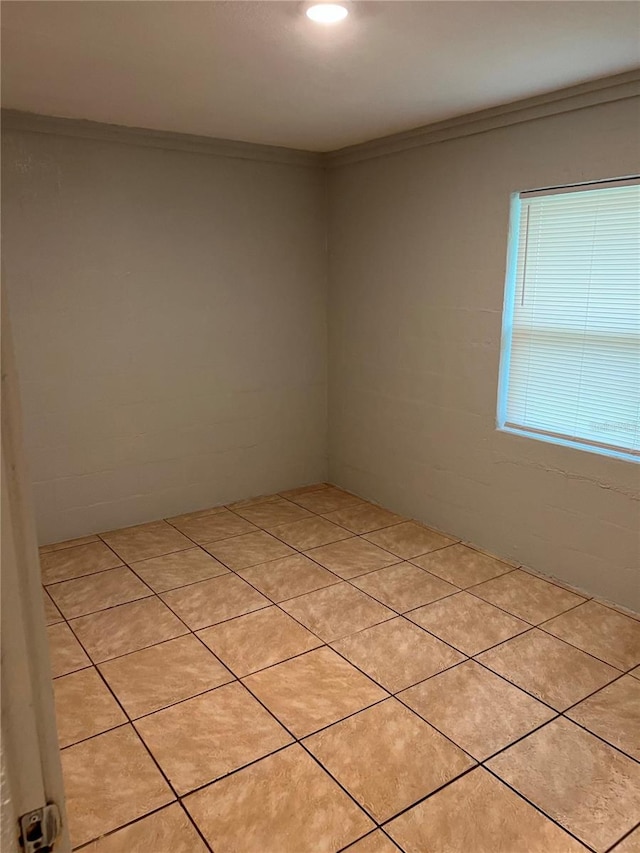 spare room featuring crown molding