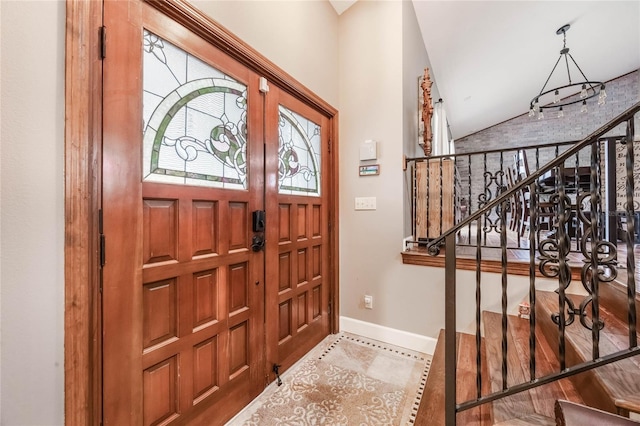 entryway featuring tile patterned flooring and lofted ceiling