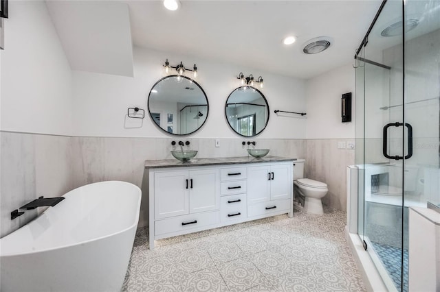 full bathroom featuring vanity, independent shower and bath, tile walls, and toilet