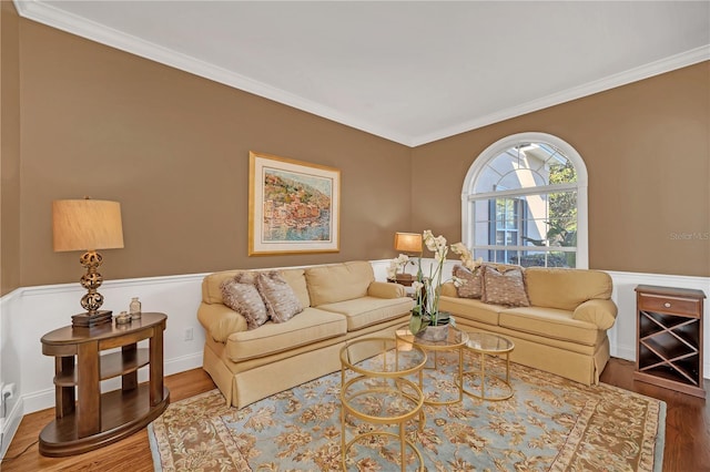 living room with crown molding and hardwood / wood-style floors