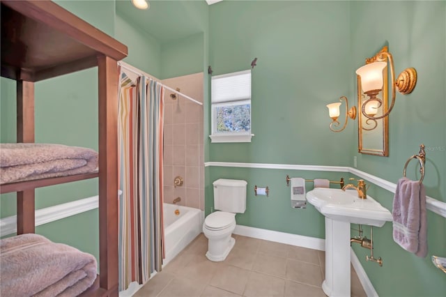 bathroom with tile patterned floors, toilet, and shower / bath combo with shower curtain