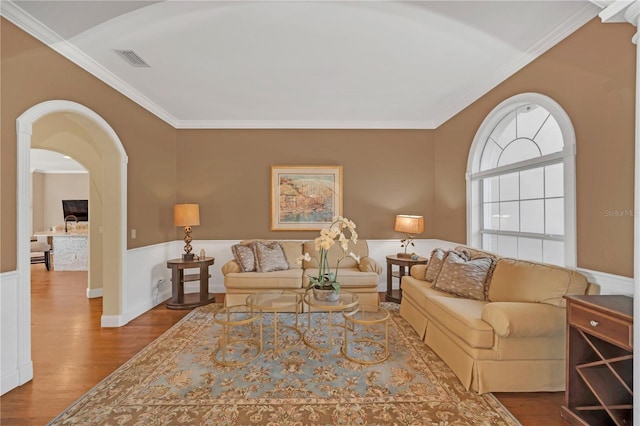 living room featuring hardwood / wood-style floors and crown molding