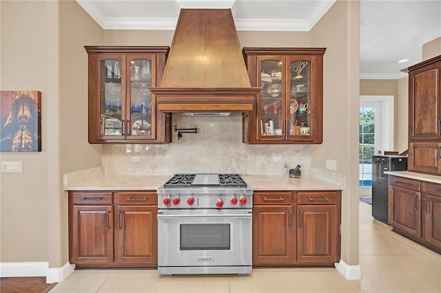 kitchen with crown molding, decorative backsplash, luxury range, and premium range hood