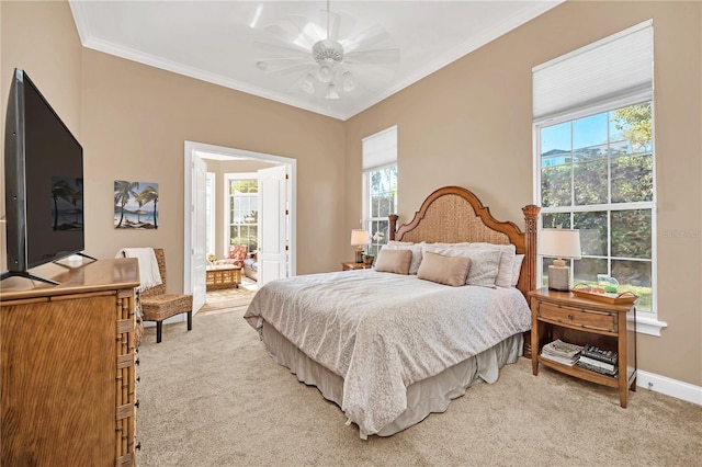 bedroom featuring crown molding, light colored carpet, ceiling fan, and ensuite bathroom