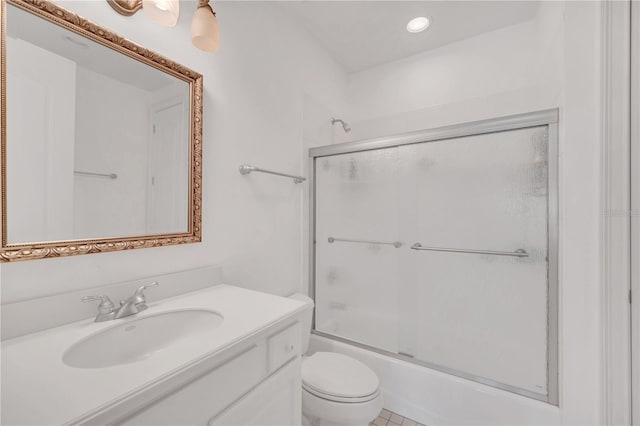 full bathroom featuring enclosed tub / shower combo, vanity, and toilet