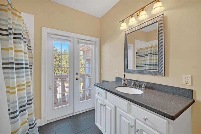 bathroom featuring french doors, tile patterned floors, and vanity